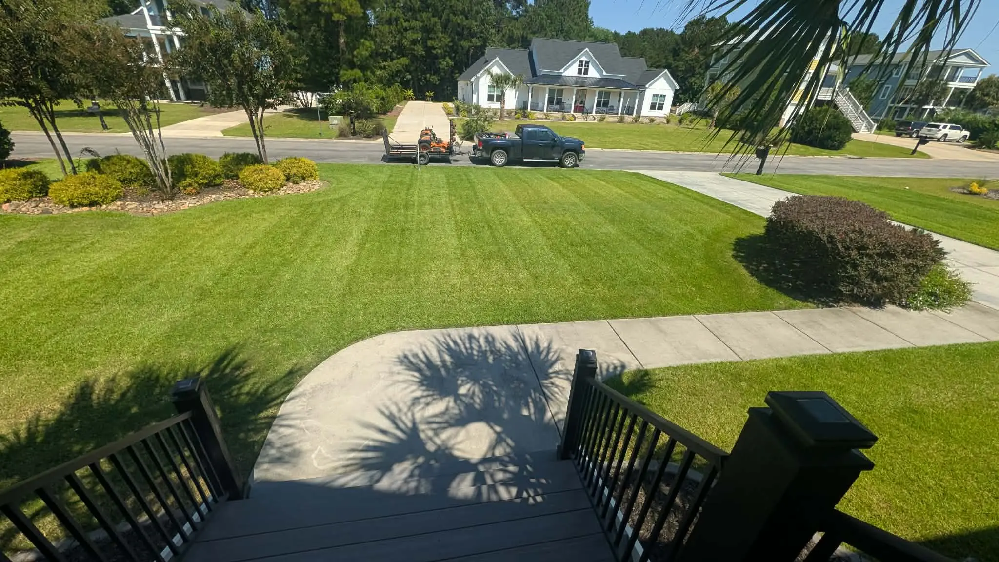 Striped lawn completed by Mako with the company truck and trailer on site